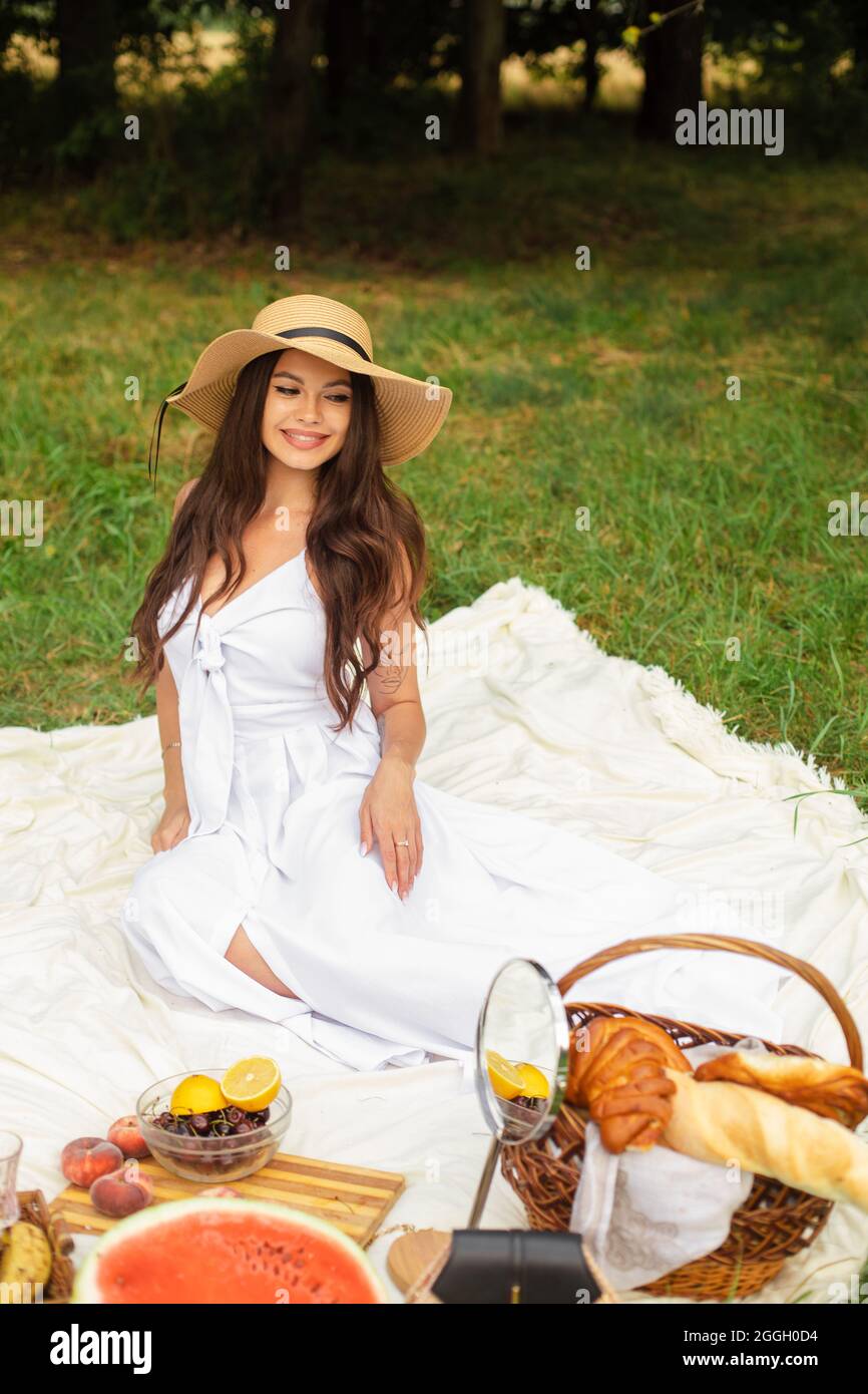 Attractive young lady posing near tree in the park Stock Photo - Alamy