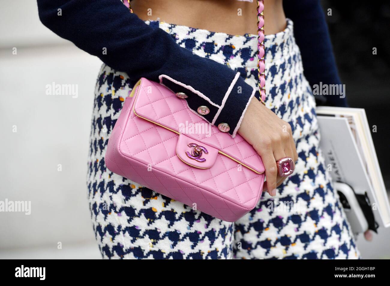 Guest wearing a 2.55 pink Chanel bag - Streetyle at Paris Fashion