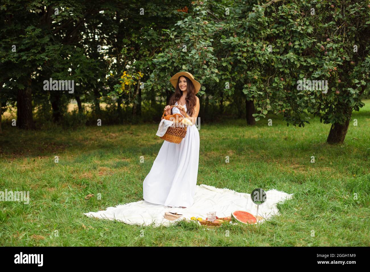 Attractive young lady posing near tree in the park Stock Photo - Alamy