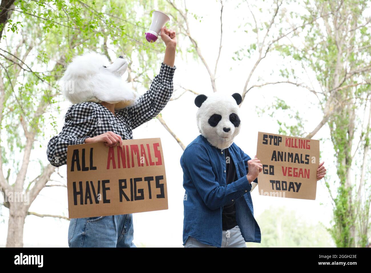 Activist protesters wearing animal masks shouting through a bullhorn ...