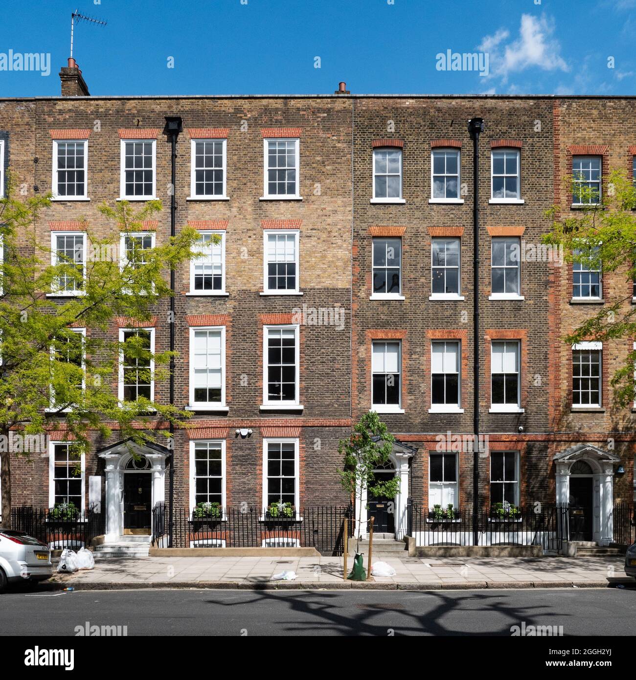 Georgian terraced town houses, London. Traditional townhouses in the Fitzrovia district of London on a bright summers day. Stock Photo