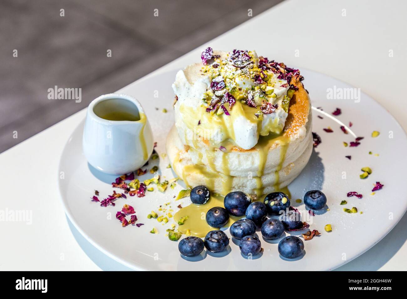 Pistachio cream Japanese soufflé pancakes topped with pistachio cream