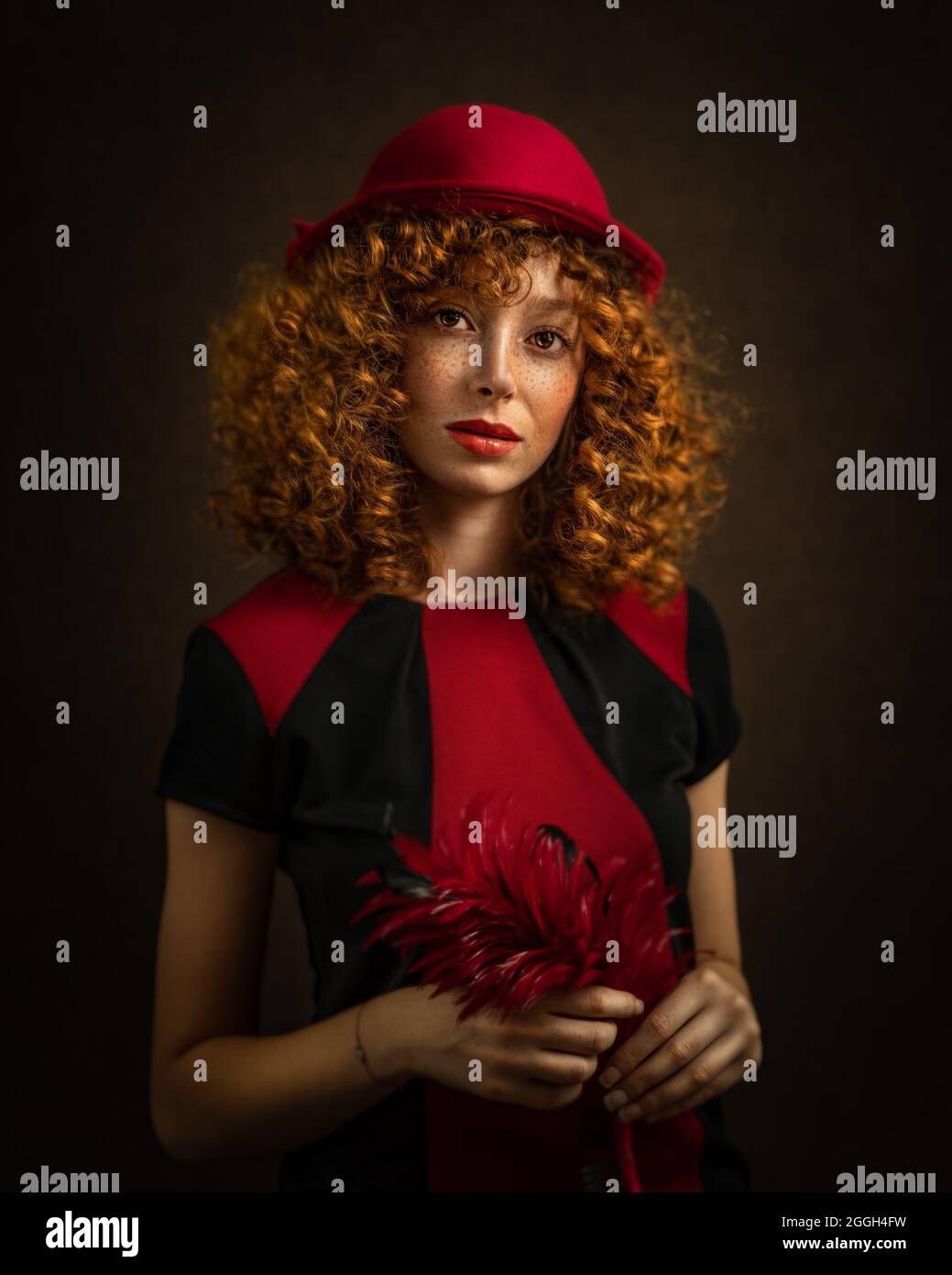 Portrait of a beautiful woman with nostalgic red and black 1940's style outfit and hairstyle on dark background. High quality photo Stock Photo
