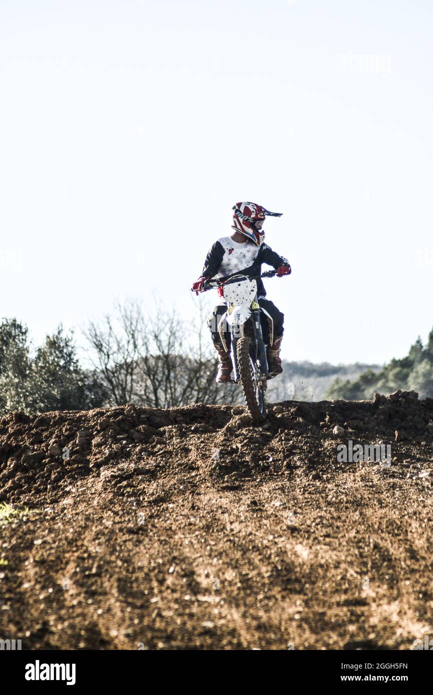Boy looking to the side while riding a motocross bike Stock Photo