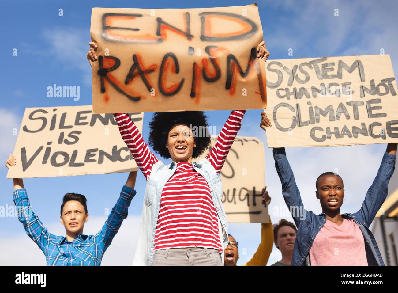 Diverse crowd of people holding placard at protest march Stock Photo