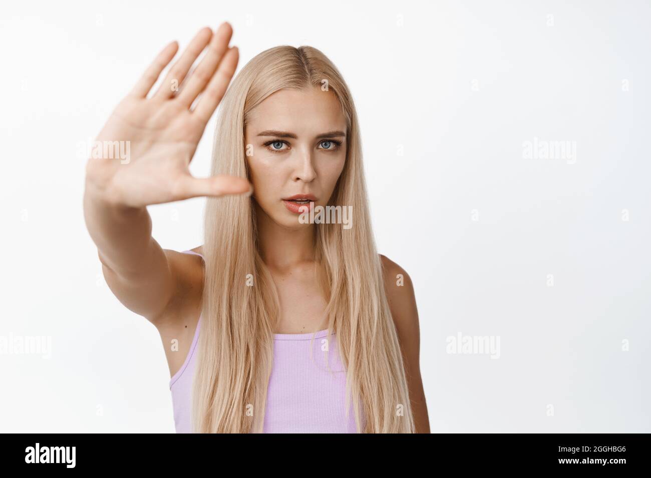 Serious young woman asking to stop filming her, showing no, rejection ...