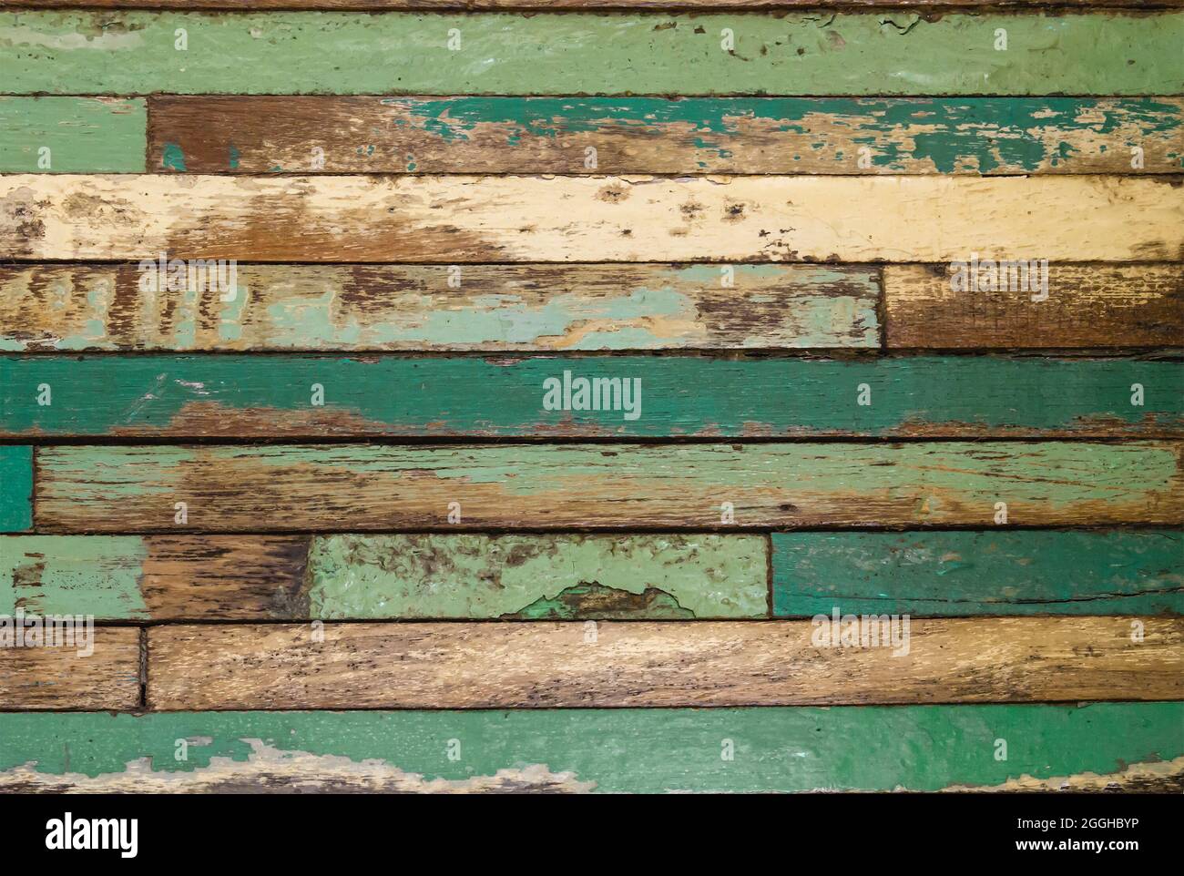 Old distressed green painted rustic wooden wall background or texture