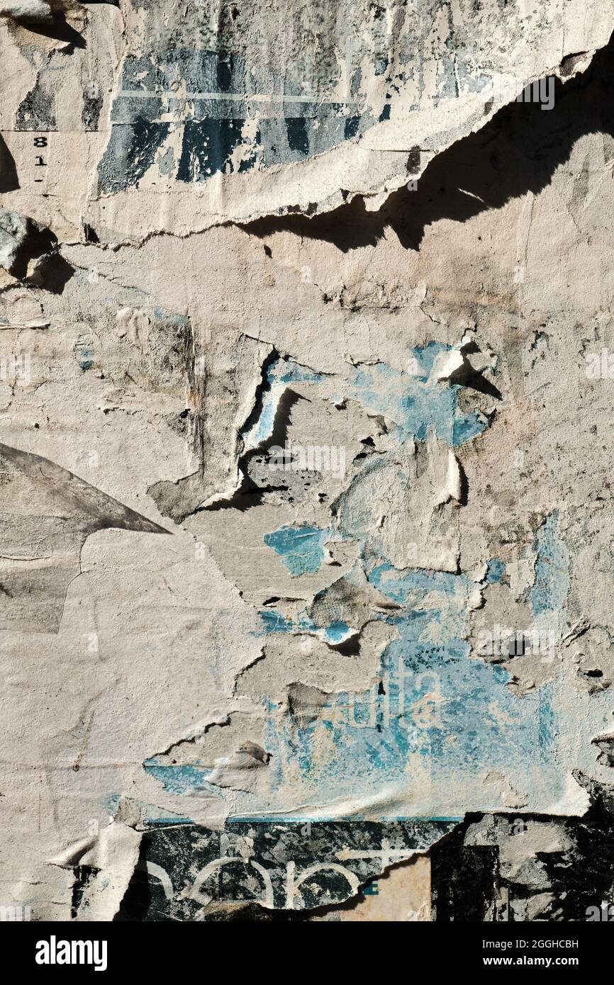 Faded away peeling posters on old weathered bulletin board, worn out grunge  background or texture Stock Photo - Alamy