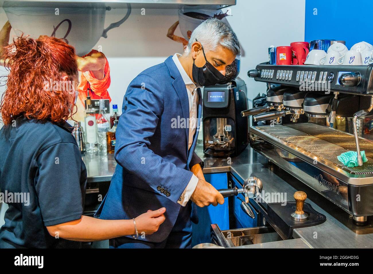 London, UK. 1 Sep 2021. Having a go at making a coffee - Mayor of London Sadiq Khan visits food and drinks market Mercato Metropolitano (MM) at their site in Elephant and Castle to speak about his skills offer to Londoners and his plan for skills academies. This offers unemployed and low-paid Londoners the chance to retrain for free to secure qualifications and jobs in a range of industries including hospitality, digital, health and the green economy. The Mayor meets students who have recently completed courses in the hospitality and digital sectors includes two learners who have benefitted fr Stock Photo