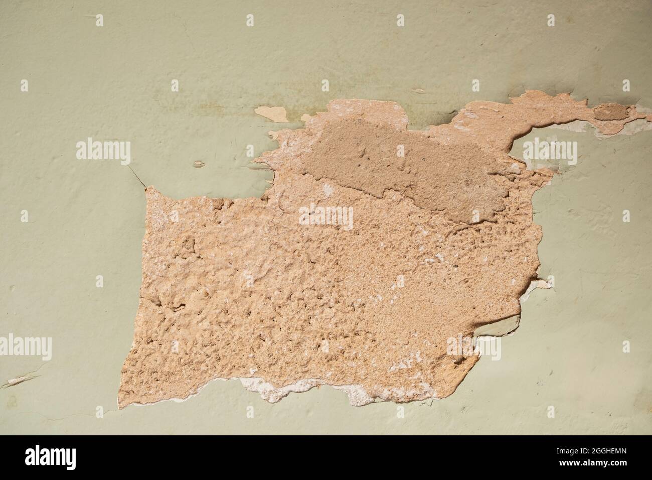 Light green wall peeling paint. Stock Photo