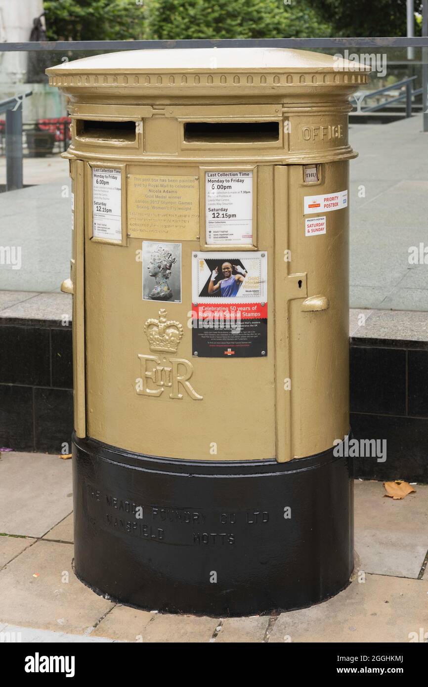 Royal Mail post box painted gold in honour of UK Olympic boxing champion Nicola Adams the Headrow Leeds West Yorkshire England UK Stock Photo