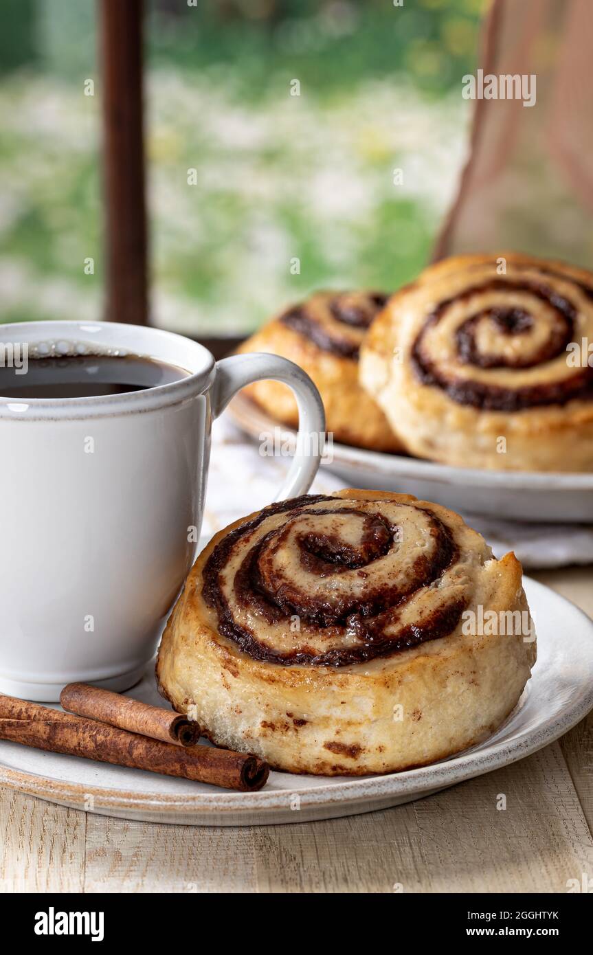 Glazed Cinnamon Roll And Cup Of Coffee On A Plate By A Window Stock Photo Alamy Glazed Cinnamon Roll And Cup Of Coffee On A Plate By A Window Stock Photo Alamy