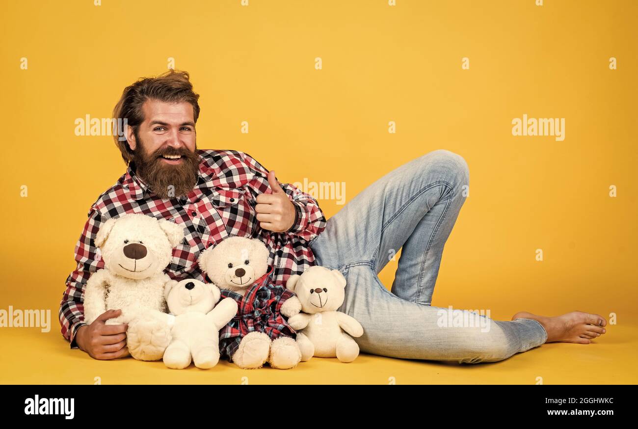 toy shop. Holiday celebration concept. Guy with happy face plays with soft toy. Childish mood concept. guy enjoy valentines day. best present ever Stock Photo