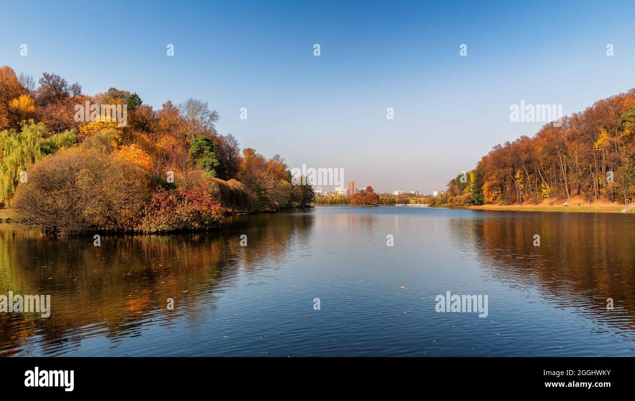 Beautiful panorama of autumn park with reflection in lake. Beautiful autumn  landscape scenery. Stock Photo