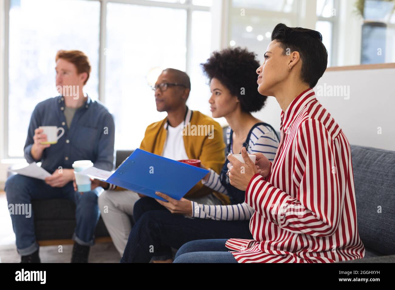 Diverse male and female colleagues working together, discussing in casual meeting Stock Photo