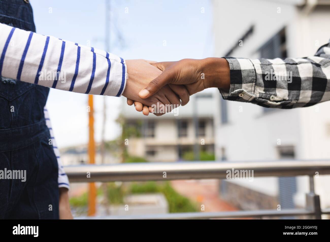 Diverse male and female colleagues at work, shaking hands Stock Photo