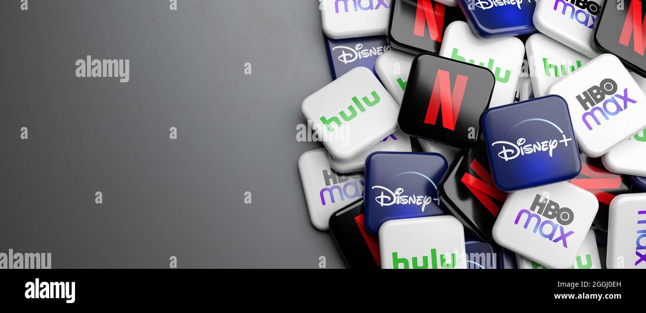 Logos of the competing on demand video streaming sites Netflix, hulu, Disney+ and HBO max on a heap. Web banner size with copy space. Stock Photo