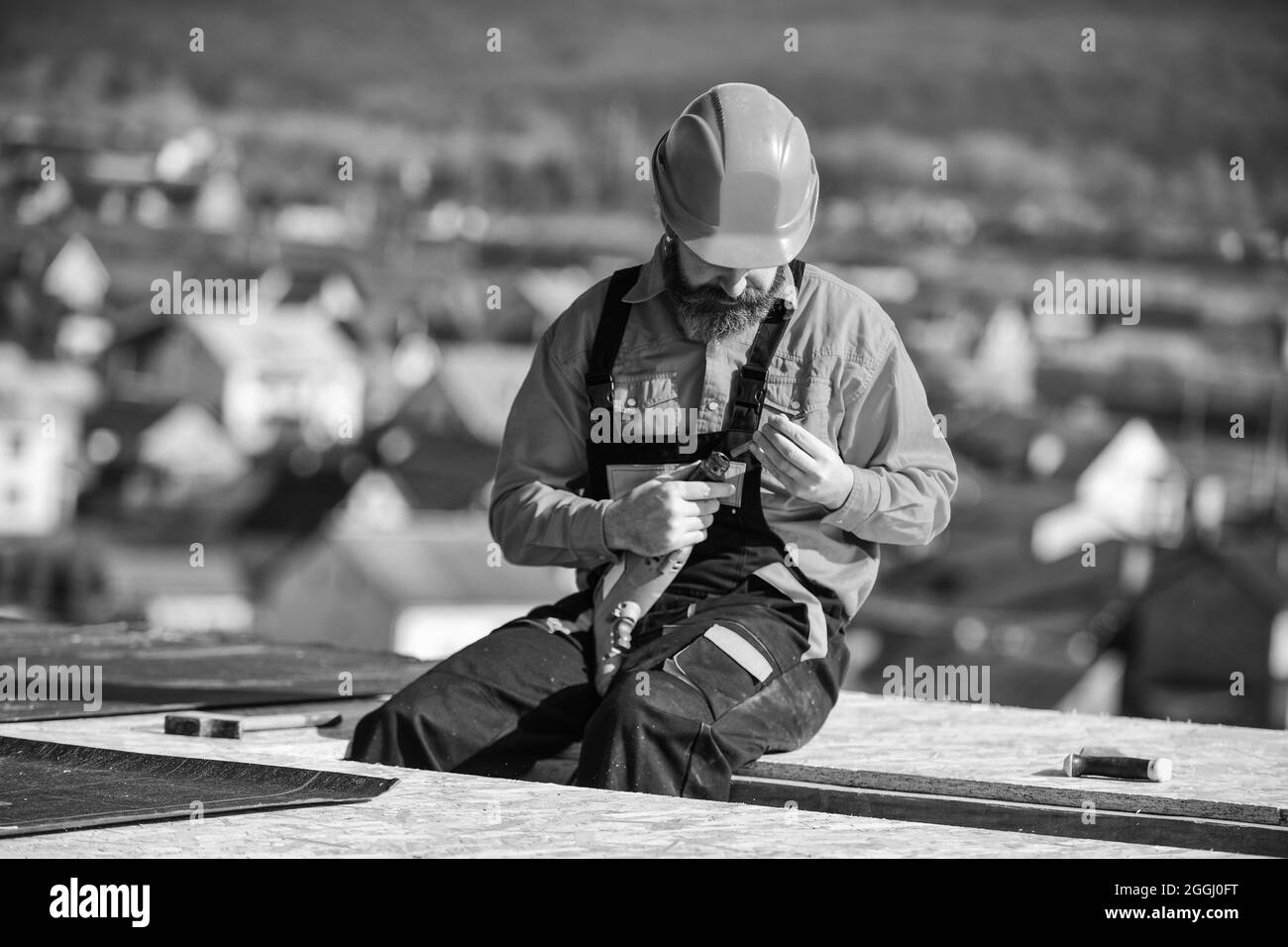 Flat roof installation. Man hard hat working outdoor landscape