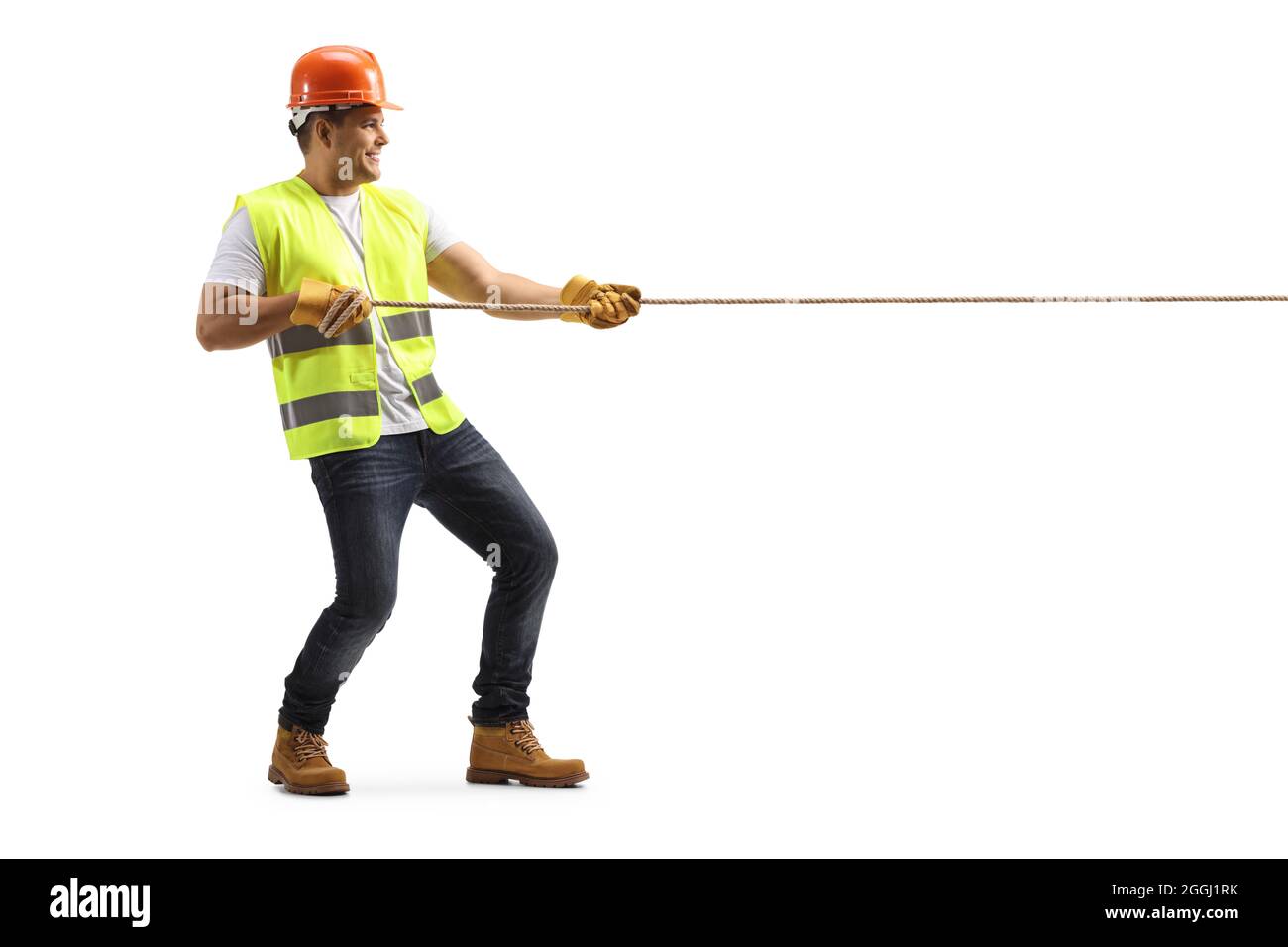 Full length profile shot of a construction worker pulling a rope