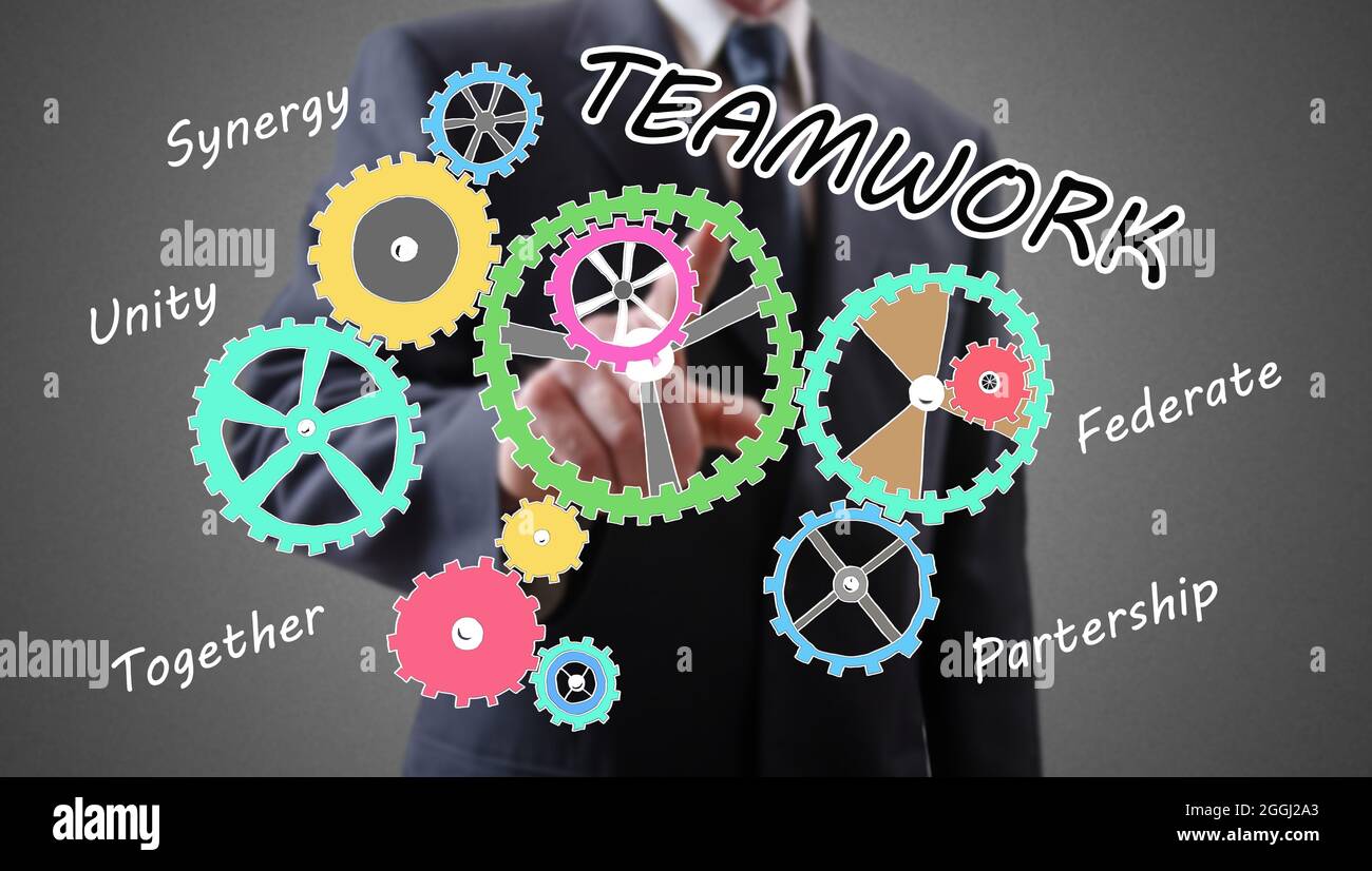 Teamwork concept shown by a businessman in background Stock Photo