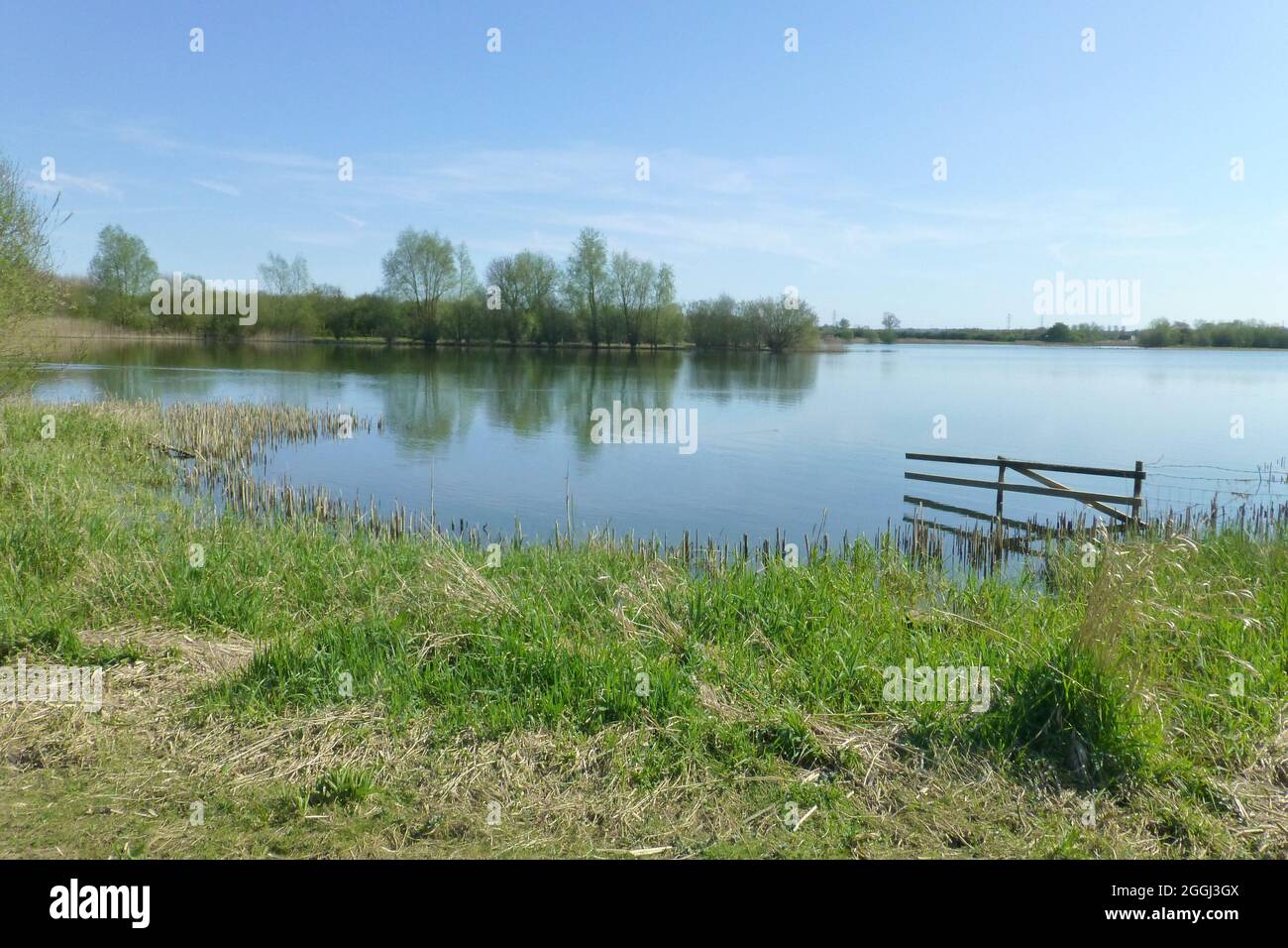 flooded gate Summer Leys Northamptonshire water pond lake reflection broken grass field underwater landscape view views cold damp wet Stock Photo