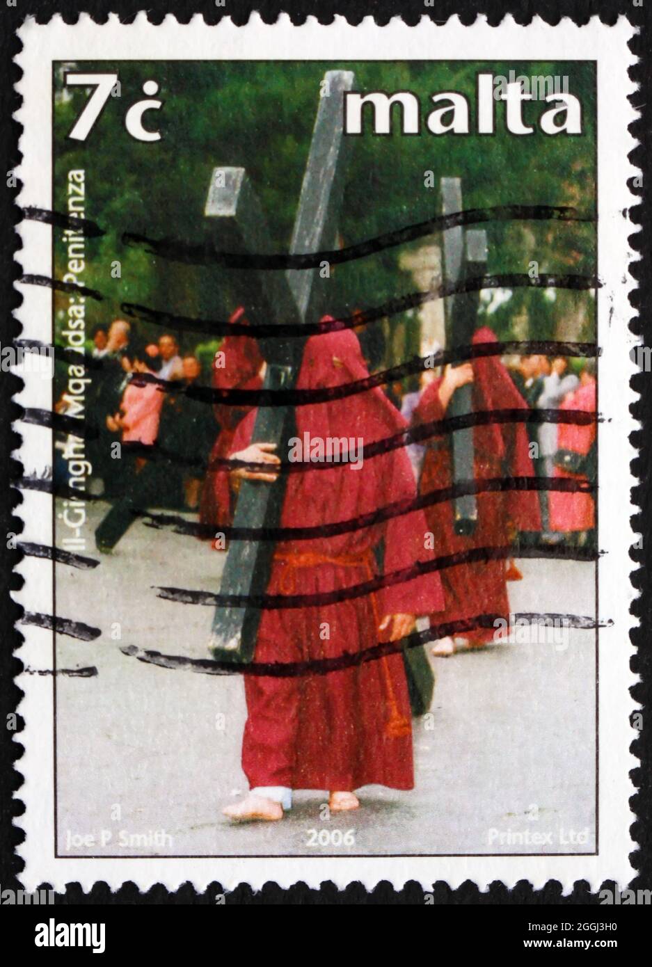 MALTA - CIRCA 2006: a stamp printed in Malta shows Men Carrying Crosses, Traditional Holy Week Celebration, circa 2006 Stock Photo