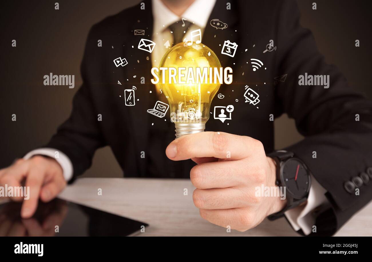 Businessman holding a light bulb, social media concept Stock Photo - Alamy