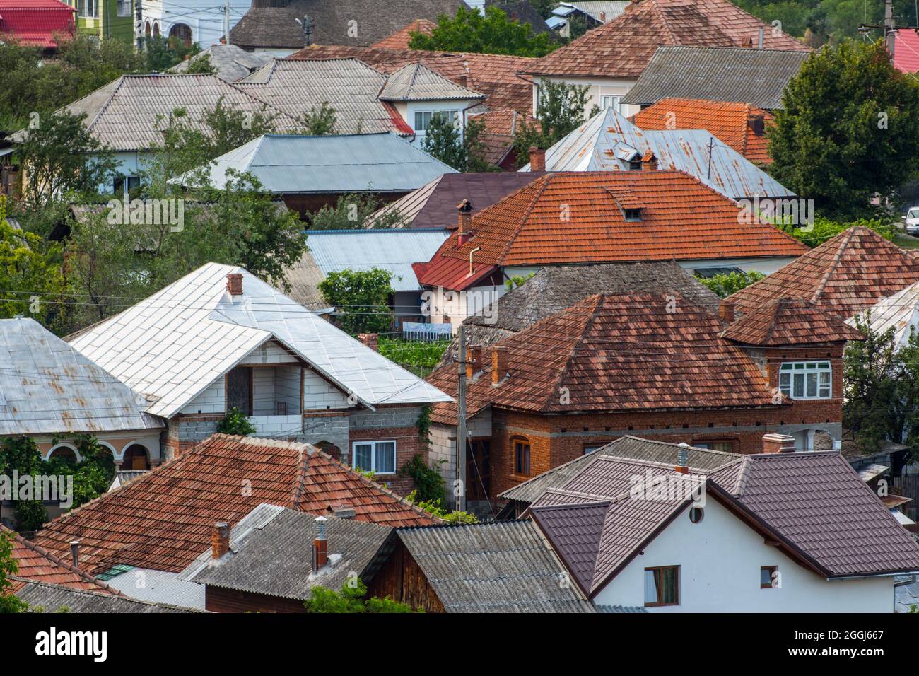 Roofs made of various materials, in a Romanian village. Stock Photo