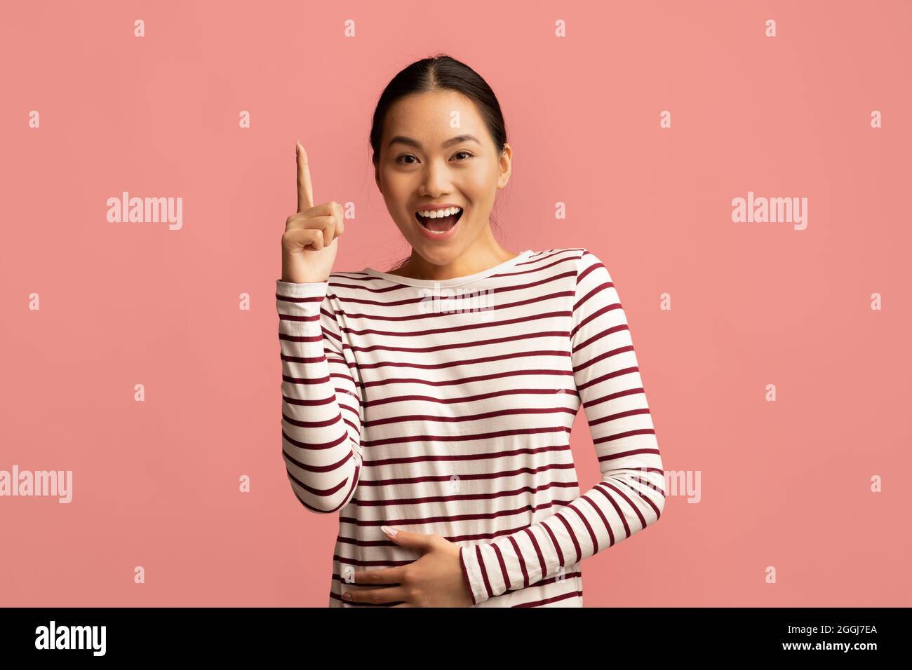 Excited Young Asian Woman Raising Finger Up, Having Good Idea, Stock Photo