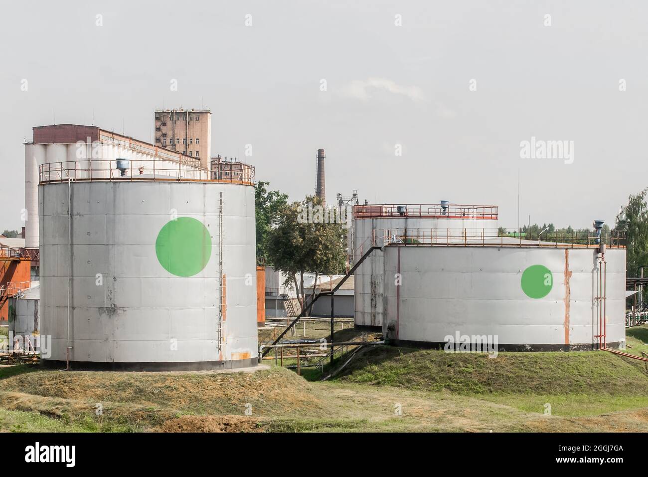 Industrial tanks for storage of oil or chemical products, fertilizers in the area of the plant at the enterprise. Stock Photo