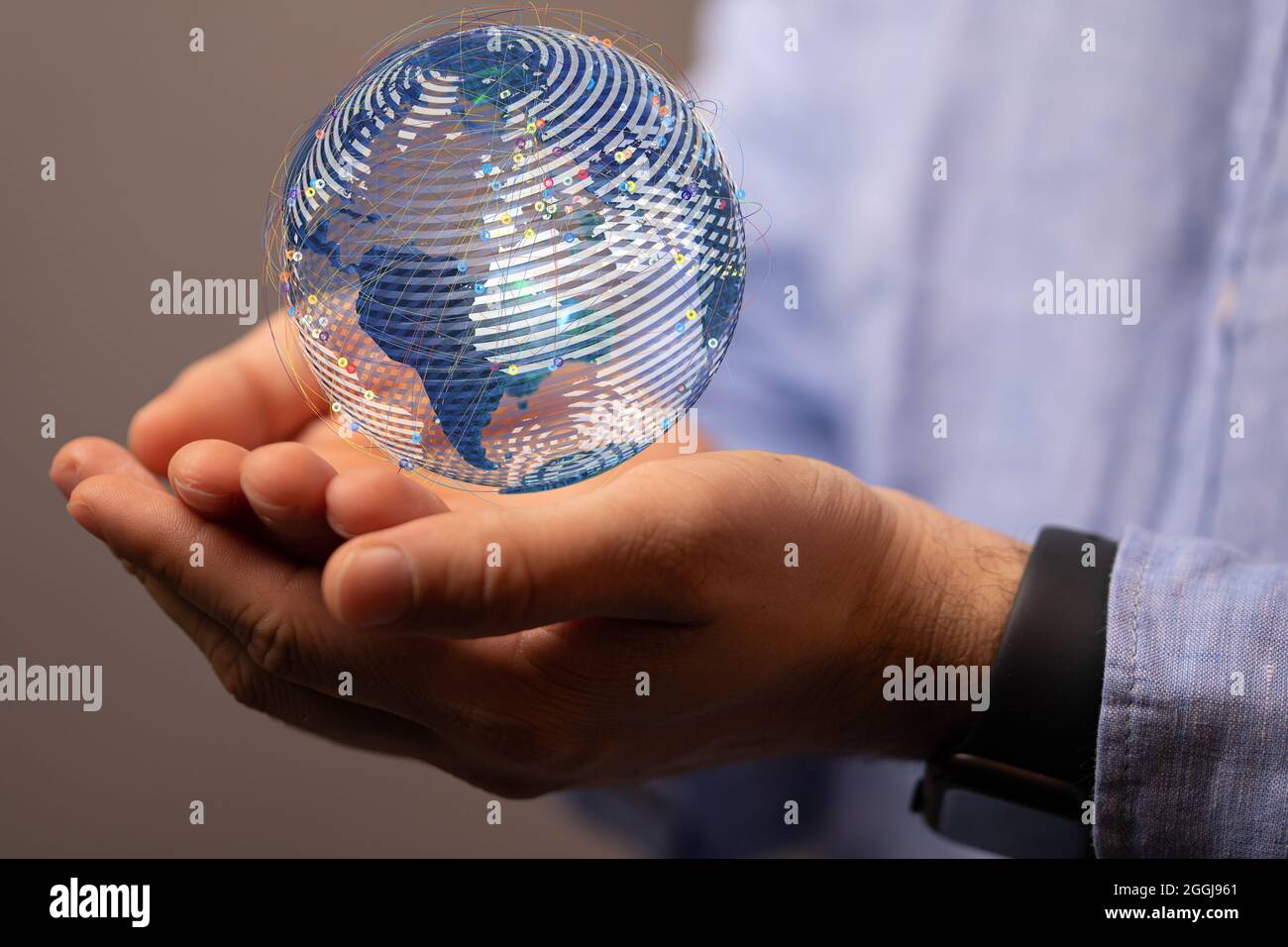 Male's hands holding a 3D rendering illustration of a digital earth ...