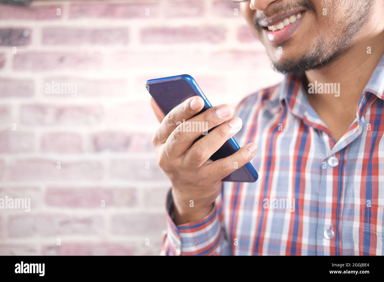 happy young man hand using smart phone. Stock Photo