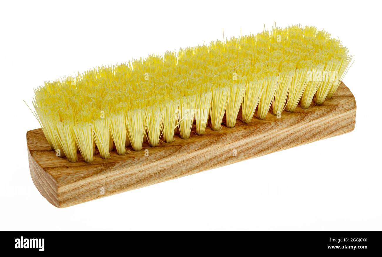 Wooden brush for clothes with yellow bristles on a white background Stock Photo