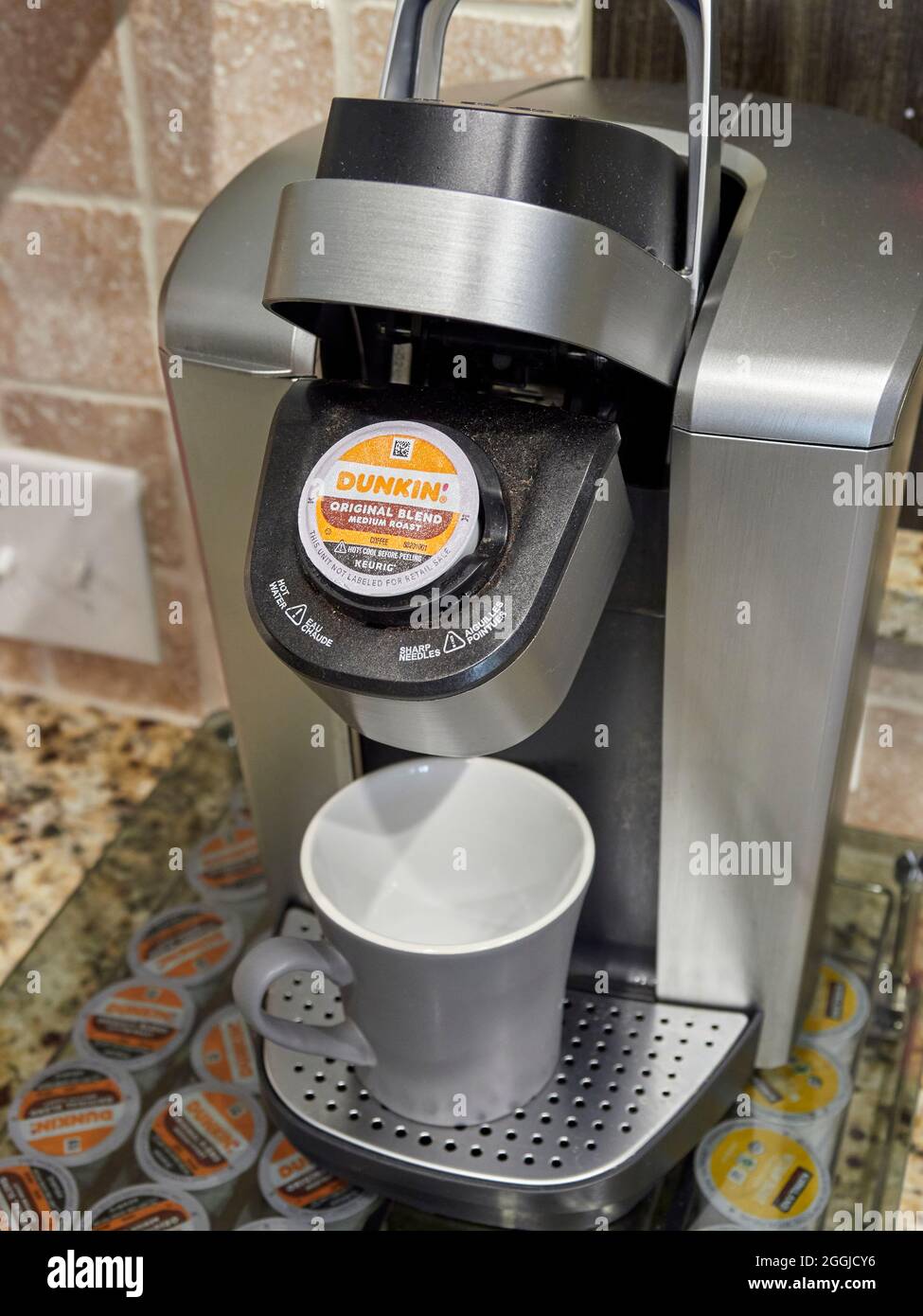 Dunkin Donuts K-cup single cup coffee in a Keurig coffee maker on a kitchen  counter Stock Photo - Alamy