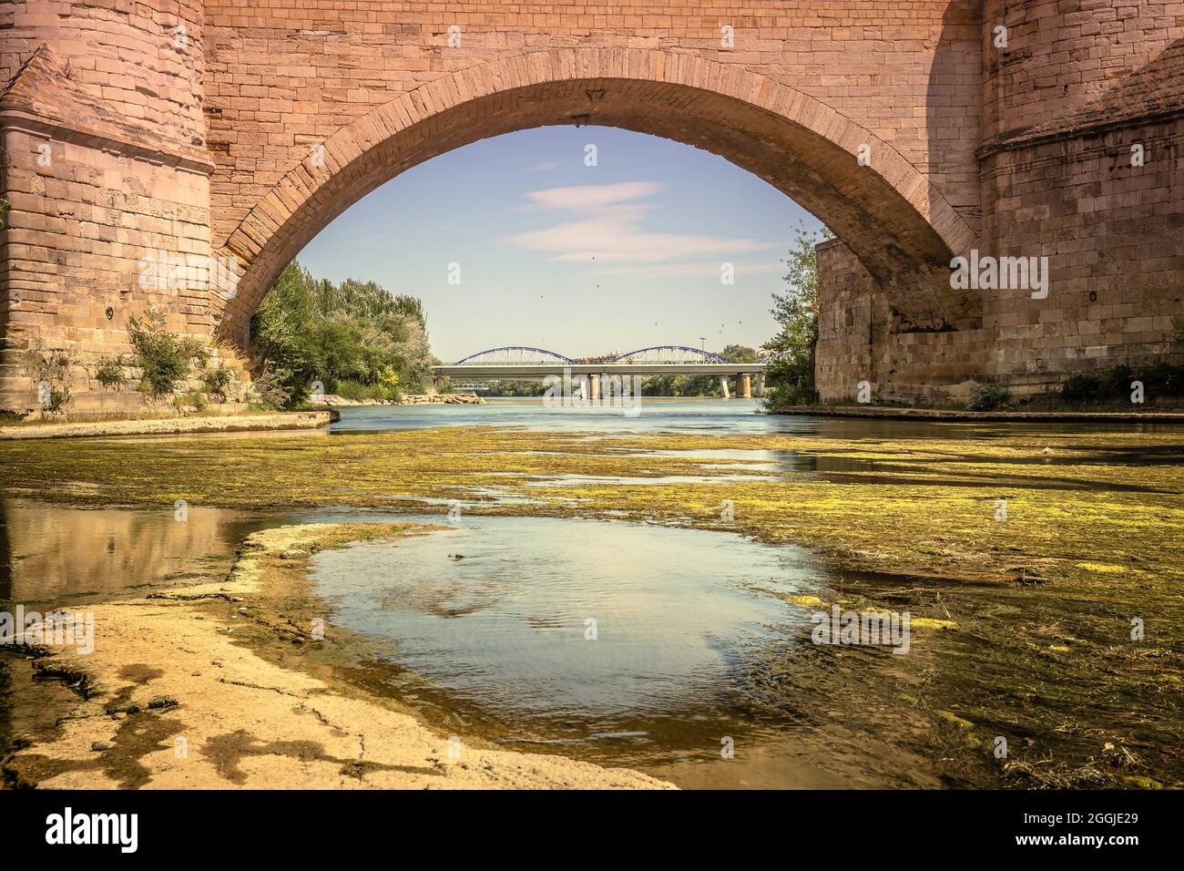 view through the stone arch of the stone bridge in Zaragoza, Spain