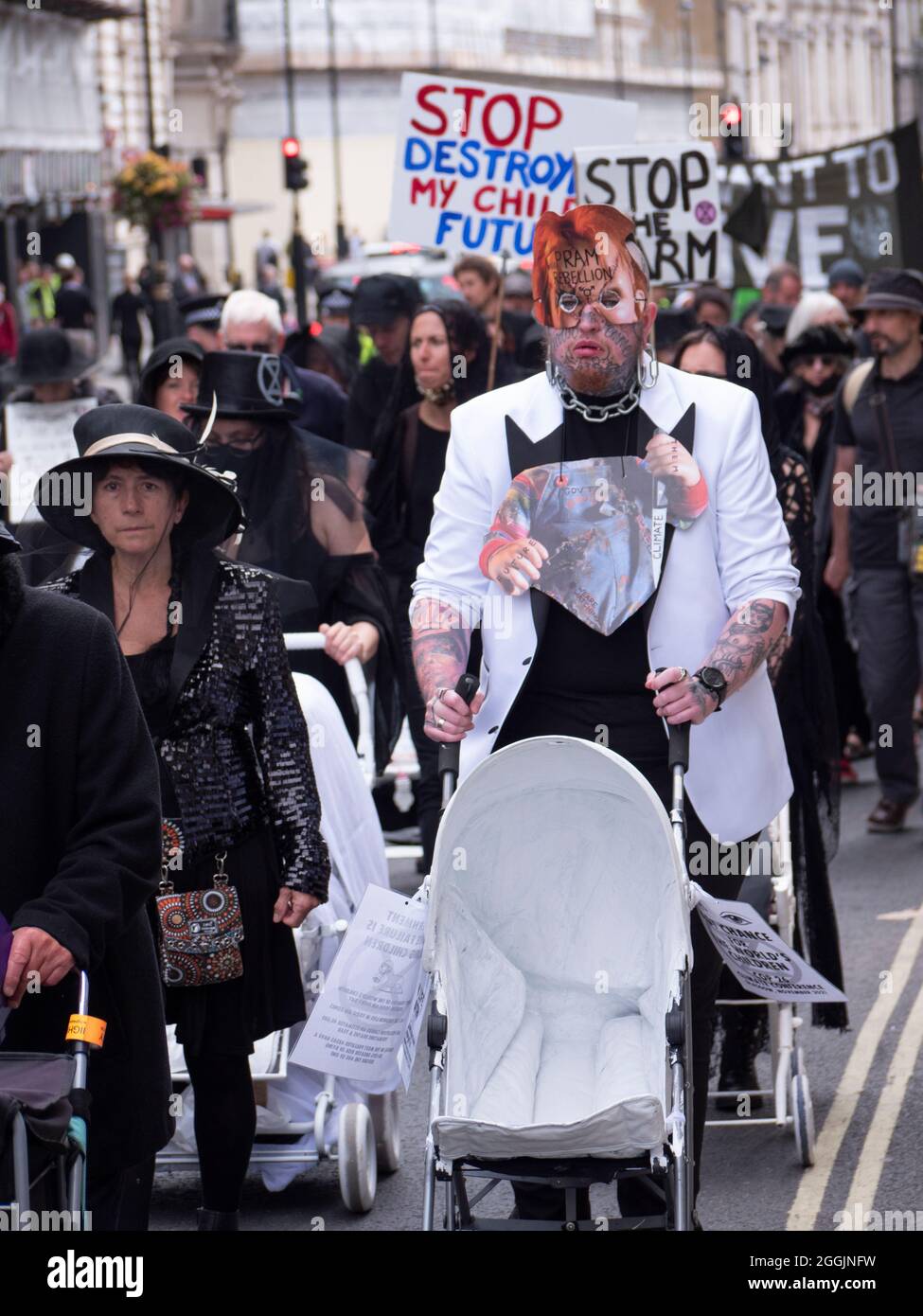 Extinction Rebellion activists London 31 August 2021. Pram rebellion action protesters in Central London, walk with ghostly white prams dressed in funeral attire Stock Photo