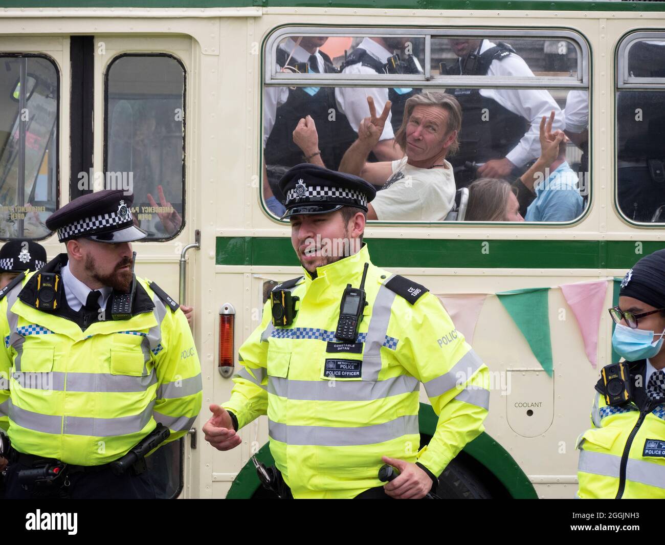 Extinction Rebellion activists London 31 August 2021. Protesters block London Bridge with a bus as part of ongoing XR, protests in London, while police officers guard bus with demonstrators on board Stock Photo