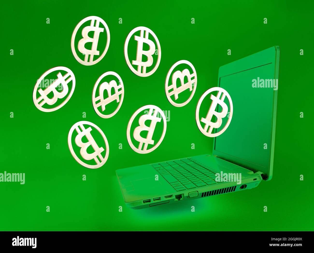 Bitcoin golden coins flying out of the laptop on green background. Bitcoin  mining business network concept and virtual cryptocurrency symbol. 3D illus  Stock Photo - Alamy