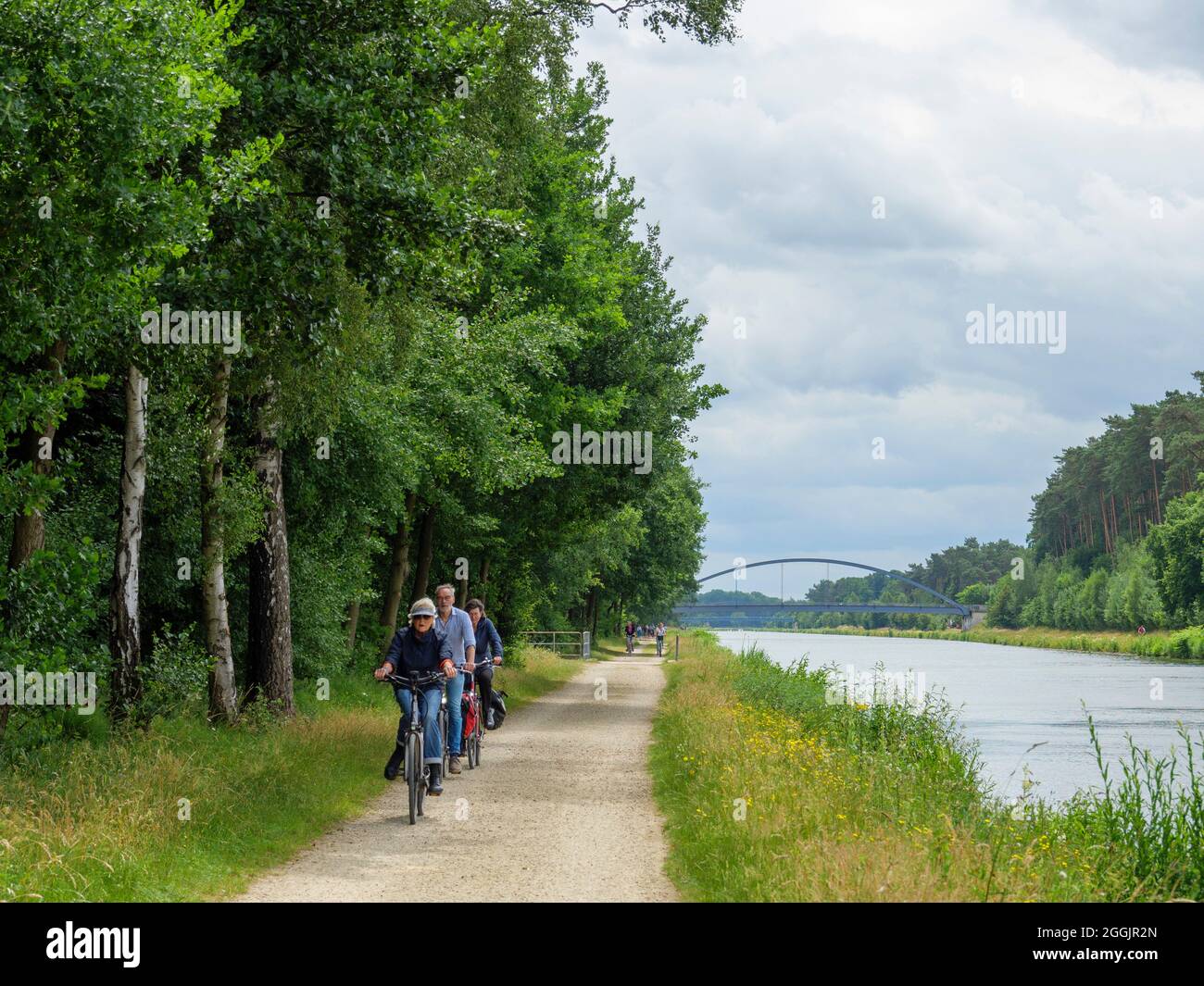Riverside path with cyclists, branch canal Osnabrück, Osnabrücker Land, Lower Saxony, Germany Stock Photo