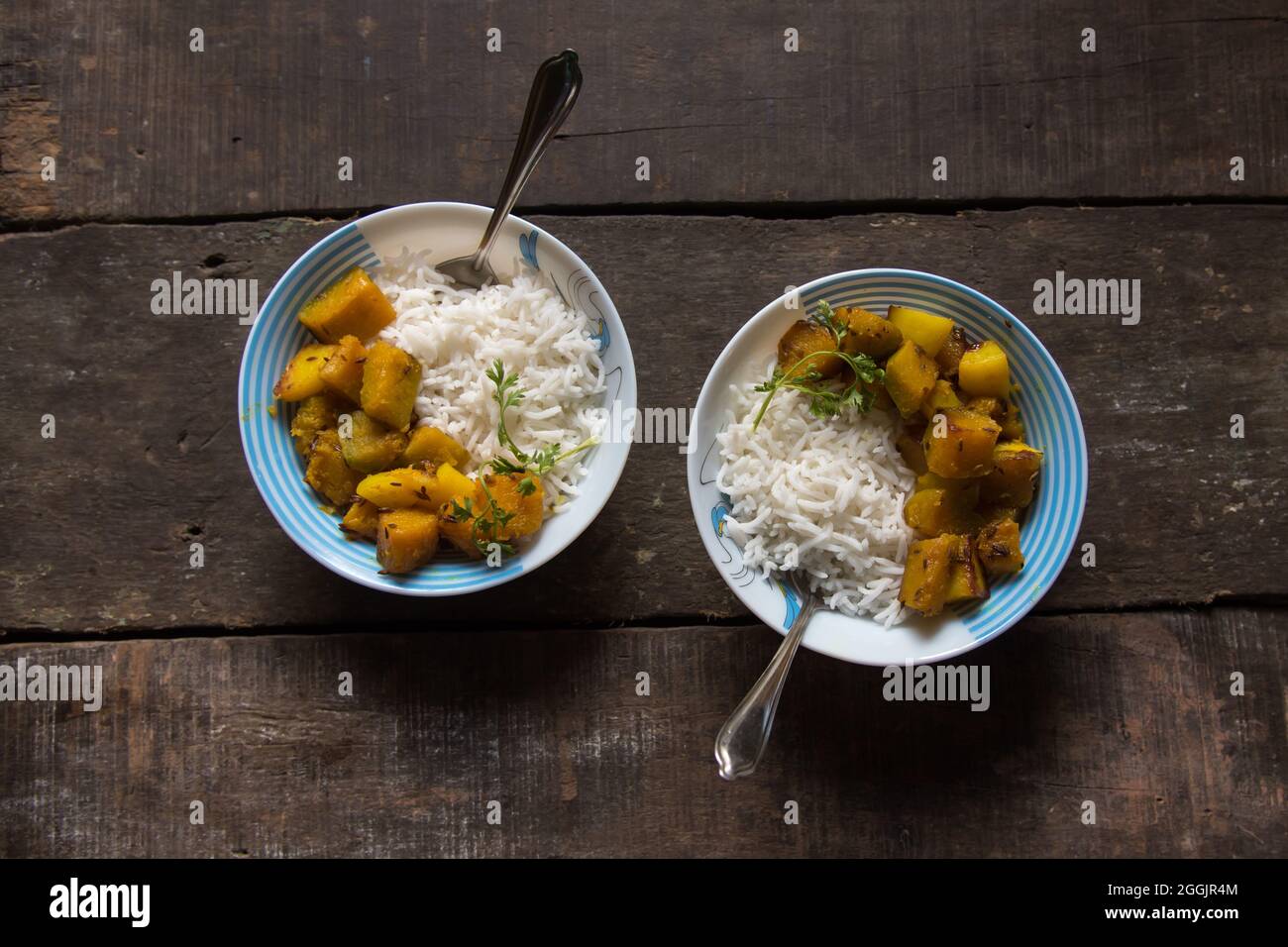Indian meal stir fried pumpkin curry and rice served in a bowl. Top view. Stock Photo