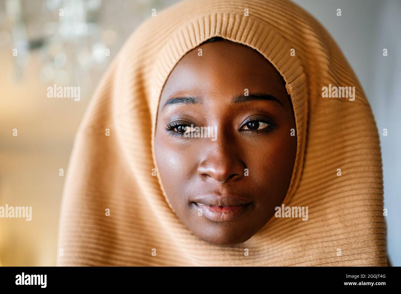 Tranquil portrait of beautiful young black muslim woman wearing hijab Stock Photo