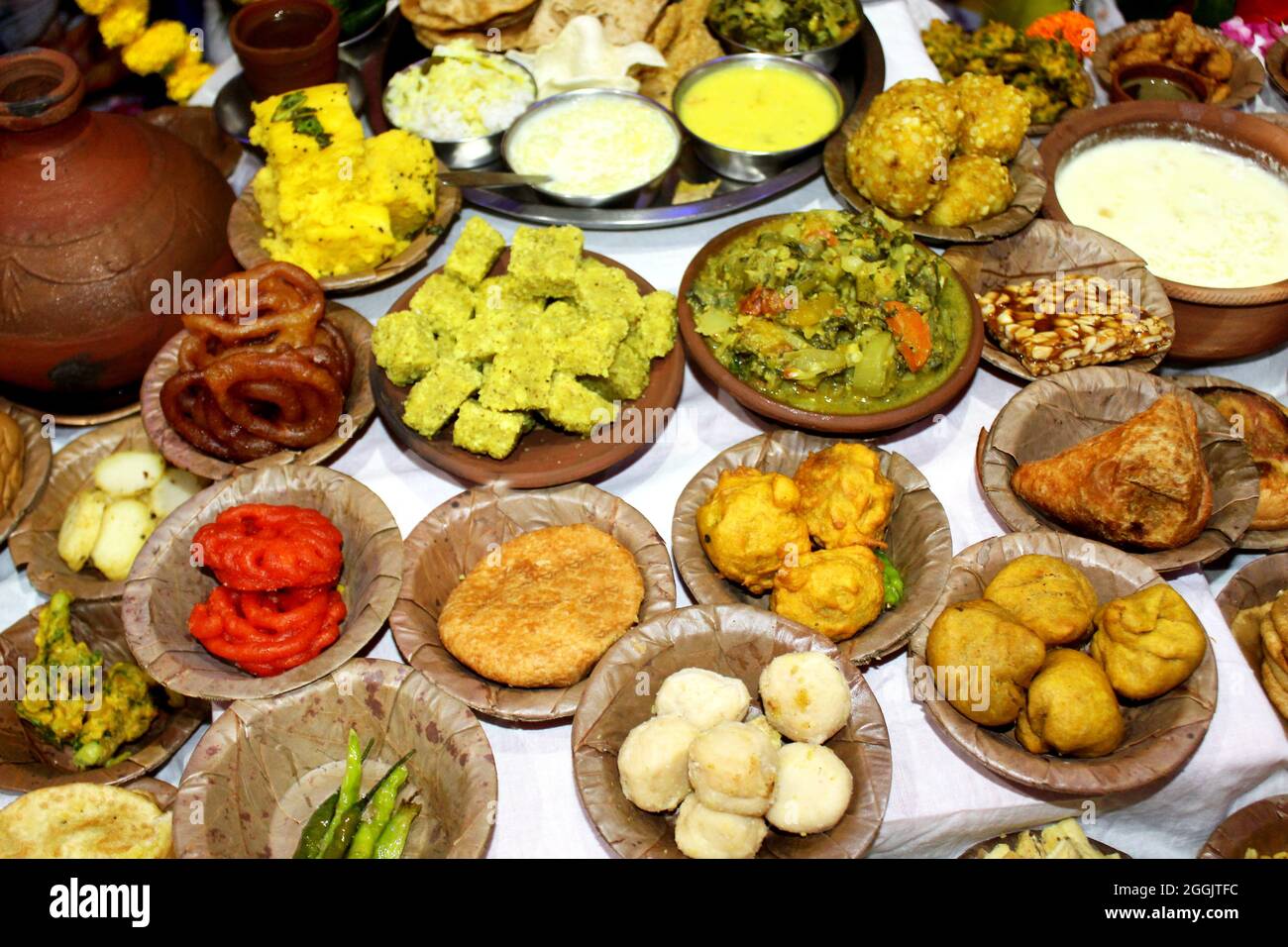 Traditional Indian Festive food and sweets serve in Bio degradable Disposable Palash (Butea Monosperma) Leaf Bowl and Dona with Indian Culture, Assort Stock Photo