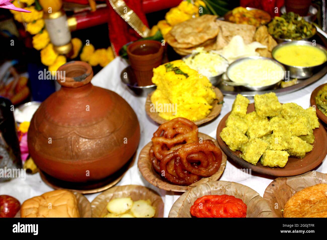 Traditional Indian Festive food and sweets serve in Bio degradable Disposable Palash (Butea Monosperma) Leaf Bowl and Dona with Indian Culture, Assort Stock Photo
