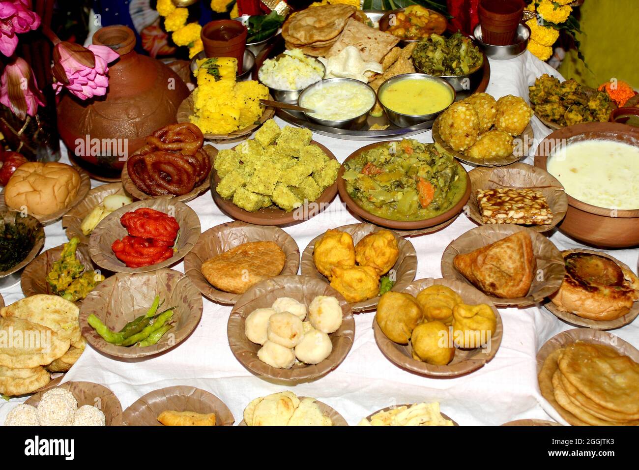 Traditional Indian Festive food and sweets serve in Bio degradable Disposable Palash (Butea Monosperma) Leaf Bowl and Dona with Indian Culture, Assort Stock Photo