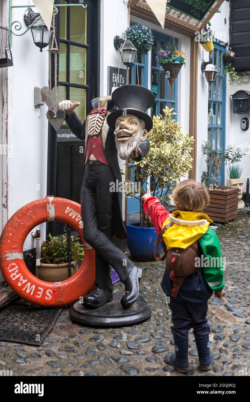 Little boy (3/4 years old) points in horror at a headless statue, Cyril Noall Square, St. Ives, Cornwall, UK Stock Photo