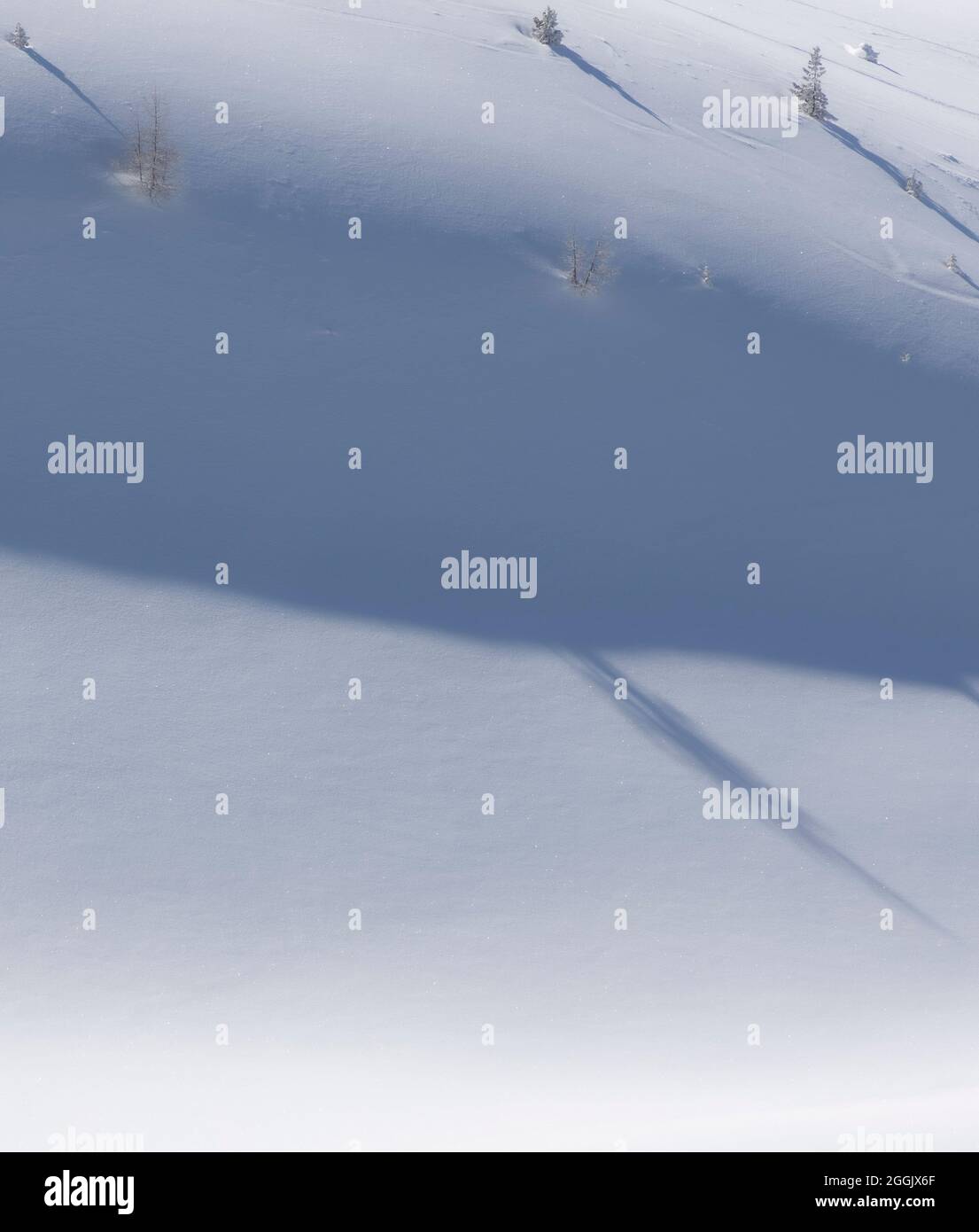 Shadows cast on the snowy mountainside Stock Photo