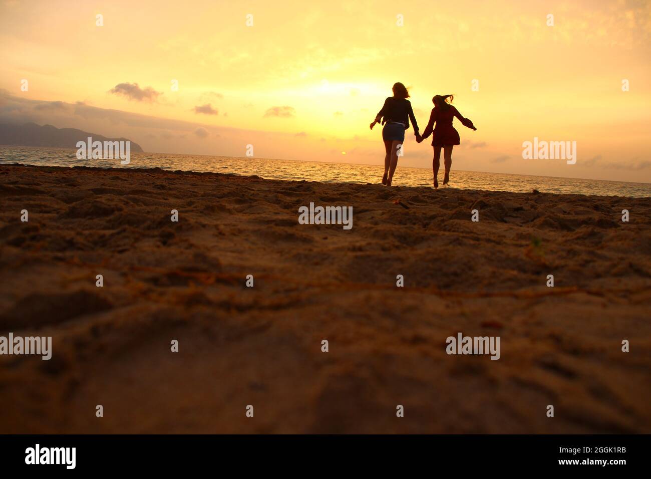 Two young women on the beach, Spain, Balearic Islands, Mallorca, Cala Millor Stock Photo