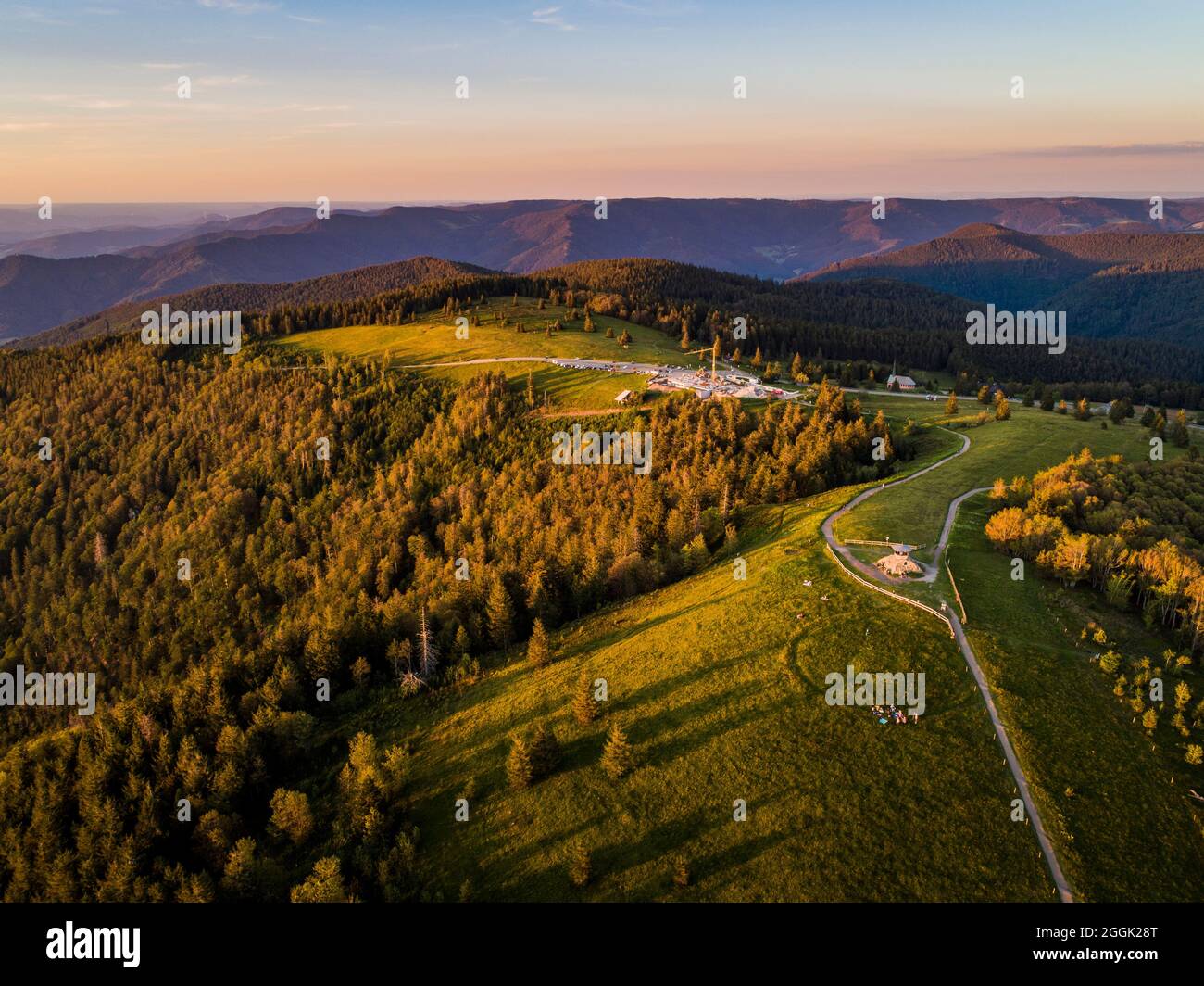 Sunset mood at the Kandel summit in the Central Black Forest. Drone photo of the Kandel summit with the summit pyramid and hikers. The Kandel is 1241.3 m above sea level. NHN the highest point in the Middle Black Forest and the local mountain of the city of Waldkirch, Emmendingen district, Black Forest, Baden-Württemberg Stock Photo