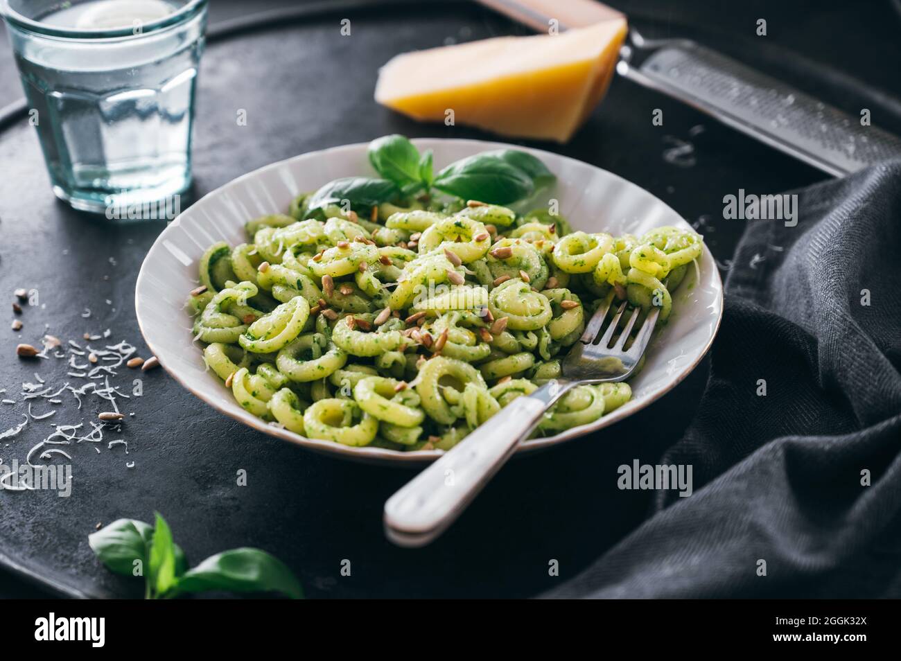 Volanti with green pesto, parmesan and roasted sunflower seeds Stock Photo