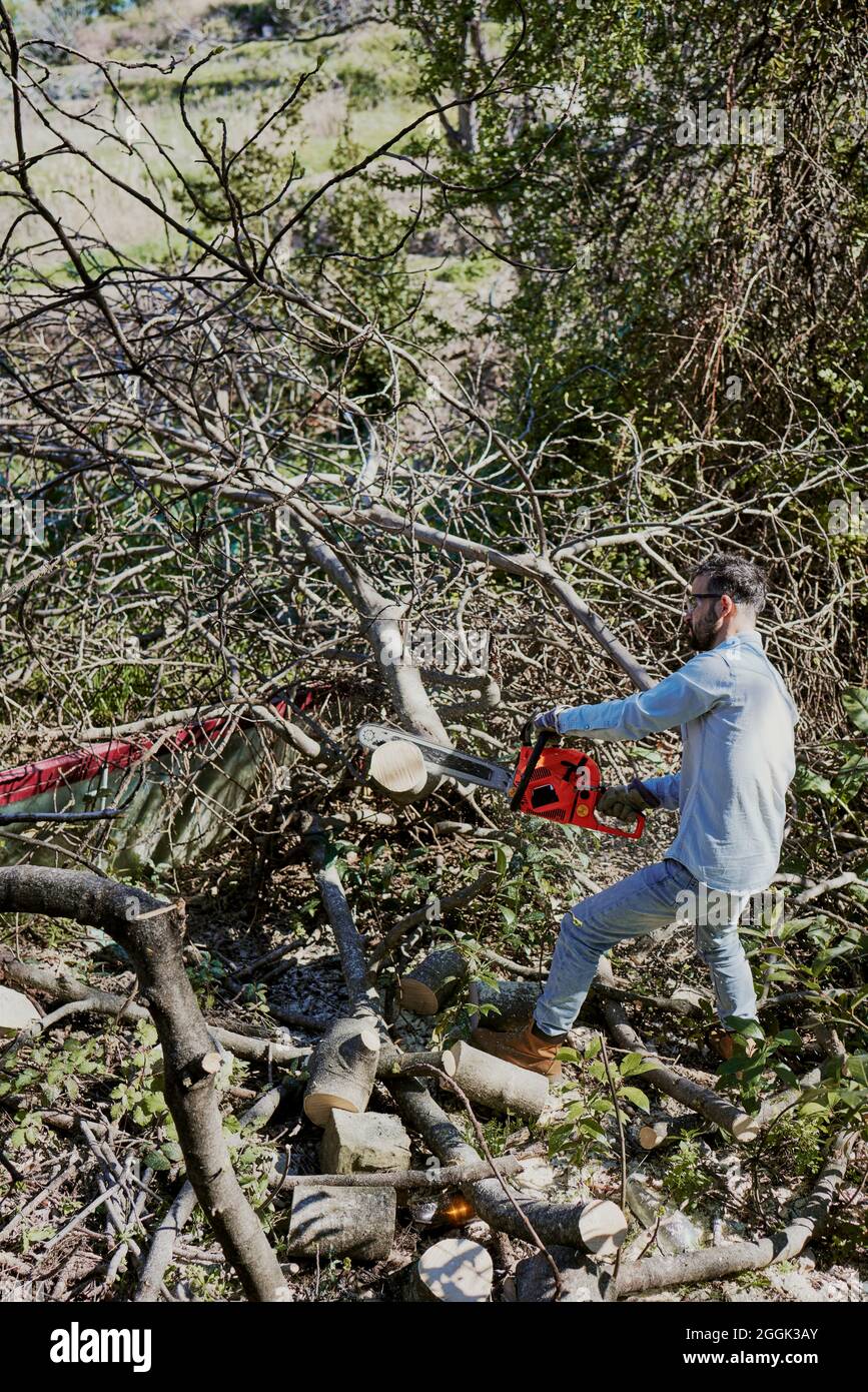 Man using chainsaw cut log hi-res stock photography and images - Alamy